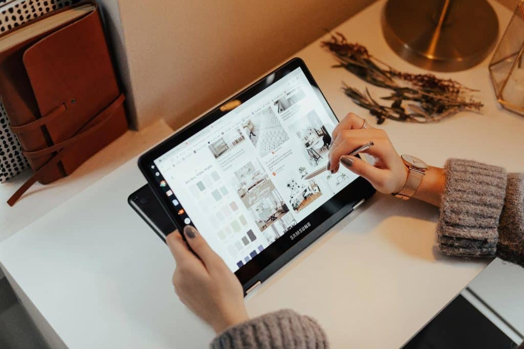 Architect discussing design plans with clients over a digital tablet