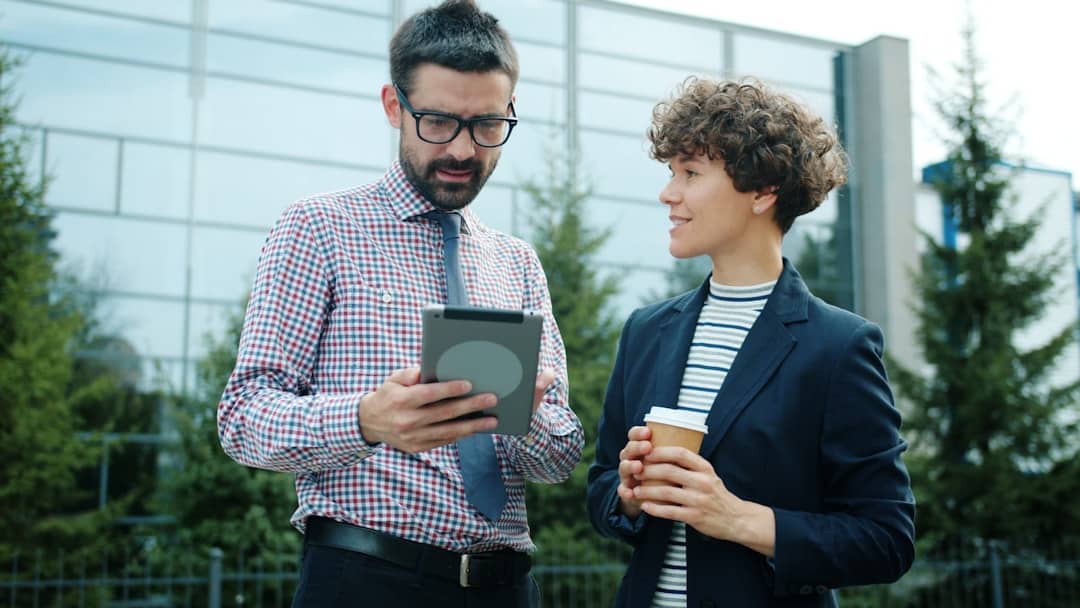 Professionals Reviewing Plans on Tablet