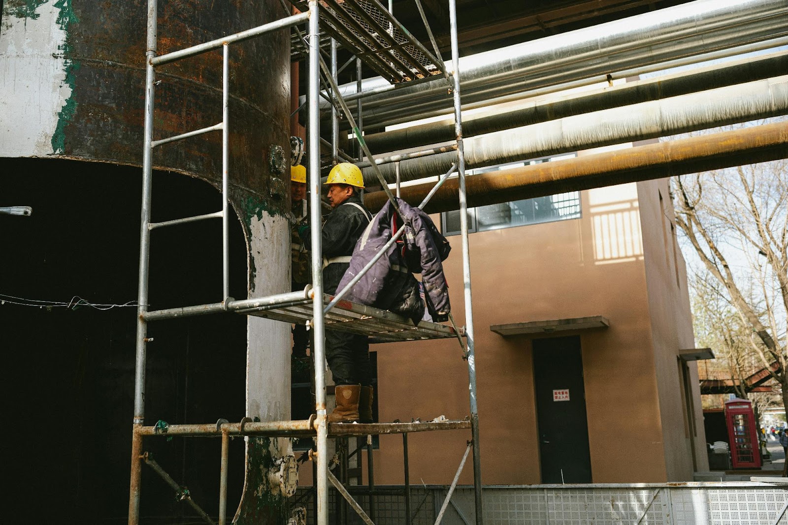 Workers Inspecting Pipes and Structure