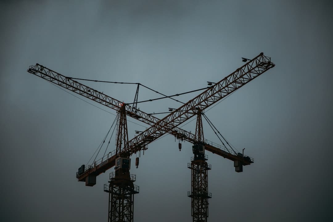 Construction cranes representing technological advancements in modern building codes and safety standards